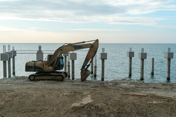 Excavator Preparing Site by Calm Ocean Water