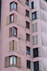 Fototapeta premium Residential Building Facade with Repeating Windows and Shutters