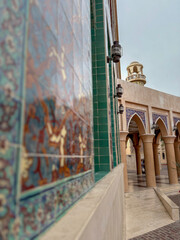 Vibrant Islamic Tile Mosaic with Mosque Arches in Background. Qatar