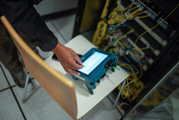 Technician Using Portable Device in Data Center