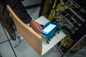 Technician Using Network Analyzer in Server Room