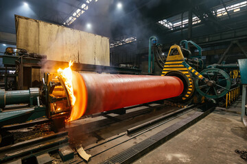 Iron pipe centrifugal pipe casting, new red hot freshly cast iron pipe at the foundry