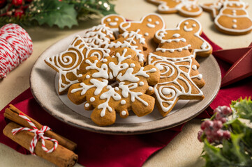 Holiday background. Christmas gingerbread cookies with icing in a plate, festive food