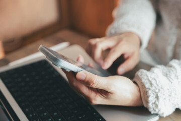 Business person using smartphone and laptop for giving online feedback and customer review. Concept of digital rating, mobile technology, service satisfaction, and user experience.
