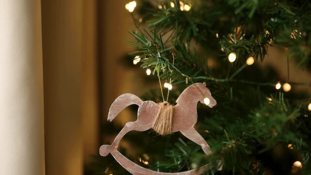 Wooden rocking horse Christmas ornament tree sparkling lights holiday mood winter 