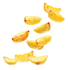Naklejka premium Baked potato wedges falling on white background