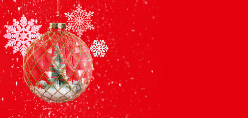 Christmas ball with fir tree inside and snowflakes on red background, banner design. Greeting card with space for text