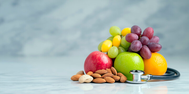 Healthy fruits, nuts and stethoscope symbolizing nutrition and heart health on marble background - Powered by Adobe