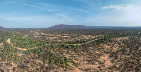 This high-quality drone photograph presents a sweeping aerial round flight over the dramatic landscapes of Namibia, offering a breathtaking bird’s-eye view of one of the world’s oldest deserts.