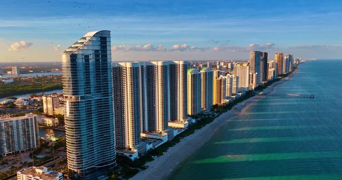 Row of the stunning modern high-rise buildings at the coast of the Atlantic Ocean. Spectacular panorama of Miami, Florida, USA from drone.