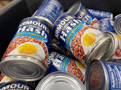 Grocery Store Armour corned beef hash in a can piled up