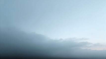 Naklejka premium Clear light blue sky transitions sharply into a dense band of moody gray clouds