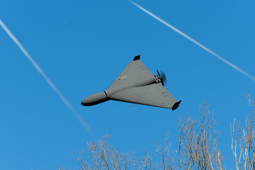 A modern military aircraft-type drone is attacking an object.