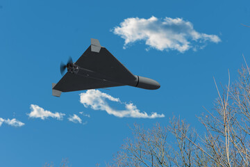 An airplane-type attack drone is flying in the sky.