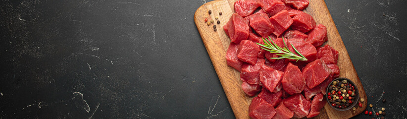 Diced cut raw beef cubes wooden cutting board red meat cooking protein top view copy space