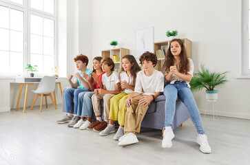 Teen group team of cheerful classmates sofa sitting tv, sport watching feeling different emotions...