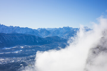Beauty of the winter Alps seen through rising fog, Austria, with mesmerizing mountain peaks
