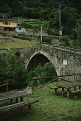 Stone roman bridge in village Villanueva in Asturias, Spain. Recreation area near medieval bridge