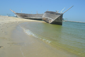 An old, broken boat looks out to sea. Hope slowly dies with it. Foggy future. 