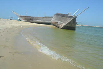 An old, broken boat looks out to sea. Hope slowly dies with it. Foggy future. 