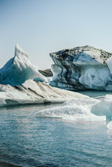 Detailed view of icebergs floating in Jokulsarlon Glacier Lagoon, Iceland. Close-up textures of melting ice and volcanic ash layers reveal the beauty and fragility of Arctic nature and climate change 