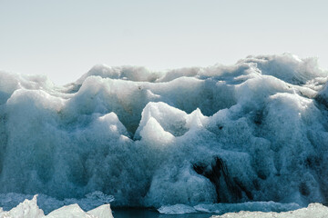 Close-up of blue ice textures from a glacier in Iceland, showing natural patterns and frozen formations