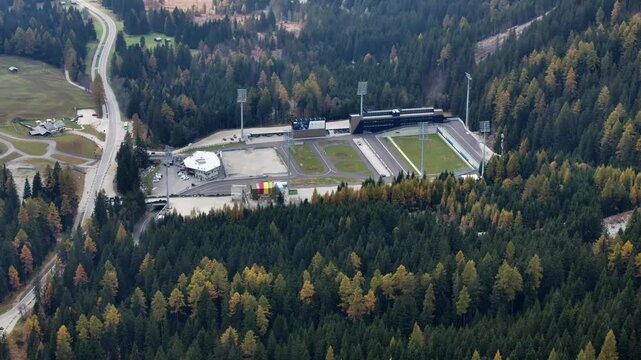 Rasen-Antholz, South Tyrol, Italy, 4k aerial video footage, flying around "S&uuml;dtirol Arena Alto Adige", a biathlon stadium with shooting range, located in Anterselva Valley during autumn