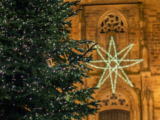Illuminated Christmas Tree and Star Decoration Outside Church