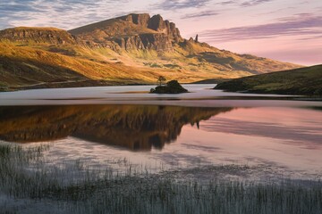 Early morning view of Old Man of Storr across Loch Leathan on Isle of Skye in Scotland, UK