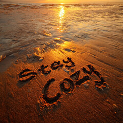 Stay Cozy Soft Natural Sand Writing with Sun Glowing Warmly and Golden Reflections Across Water with Tide &ndash; ideal for cozy seasonal promotions