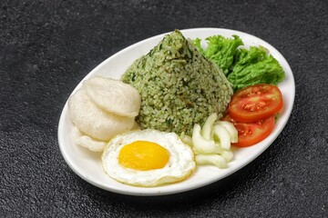 Nasi goreng cabe hijau. Green fried rice is a Indonesian fried rice that is green in color because it uses green chilies its main seasoning.