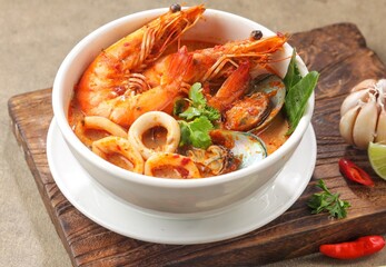 Traditional Thai soup Tom Yum kung with seafood, coconut milk and chili pepper