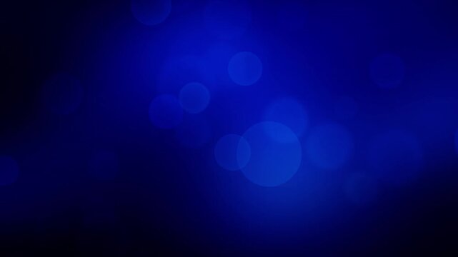 Dynamic loop background with glowing blue bokeh particle effect on a dark background. Perfect for video projects, graphic design or wallpaper.