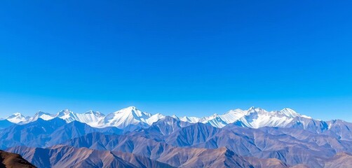 Majestic mountain range under a clear blue sky, snow-capped peaks piercing the horizon, serene beauty,  remote,  horizon