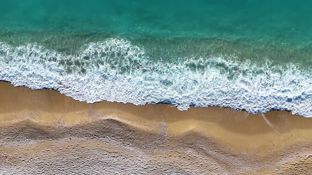 Stunning Top-Down Drone Shot of Intense White Sea Foam and Bubbles Crashing onto the Beach. High Resolution Aerial Perspective of Powerful Ocean Waves and Dynamic Coastal Movement.