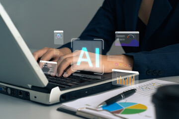 AI assistant, artificial intelligence, machine learning, digital automation, smart data tools shown business professional using a laptop in an office to work with intelligent AI interfaces.