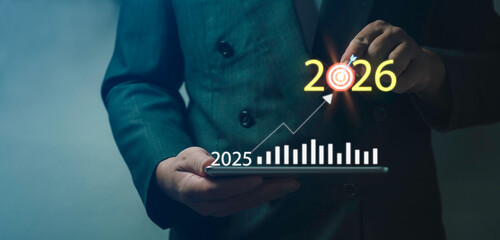 Future business targeting and strategic planning shown through businessman selecting digital goal for 2025 and 2026