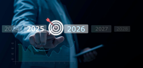 Businessman selecting digital target between 2025 and 2026 with futuristic data graphics, symbolizing goal setting, strategic planning, decision making