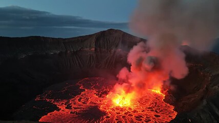 Aerial view of a volcanic caldera emitting red lava and smoke under a twilight sky