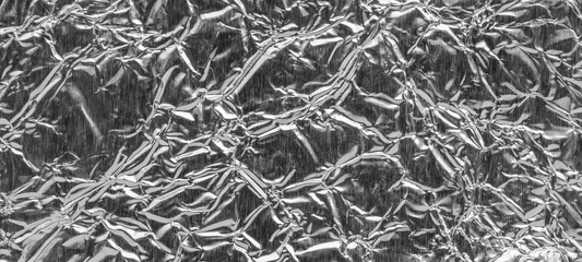 Shiny metal silver gray foil leaf crumpled texture background