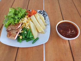 Grilled Chicken Steak with Boiled Potatoes and Mixed Vegetables on Wooden Table