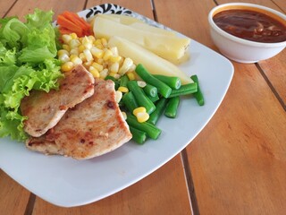Grilled Chicken Steak with Boiled Potatoes and Mixed Vegetables on Wooden Table