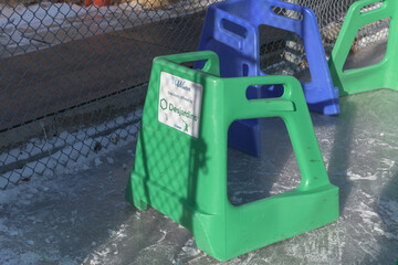 Fototapeta premium skating aids or training frames, or plastic supports shaped like walkers to help beginners balance on ice (with Desjardins logo sponsor), High Park, Toronto