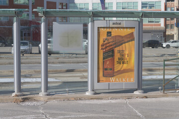 Fototapeta premium public transit streetcar shelter with street poster for Walker alcohol, Queens Quay W, Toronto