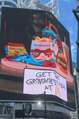 Naklejka premium McDonald's Canada holiday meal package featuring Grinchiest Meal, digital advertisement, facing Sankofa Square, Toronto
