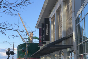 Naklejka premium hanging banners outside Loblaws Lower Jarvis Street with cargo vessel Labrador at Redpath Sugar Refinery, Toronto