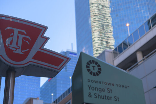 Toronto Transit Commission logo sign at Yonge and Shuter Sts with buildings
