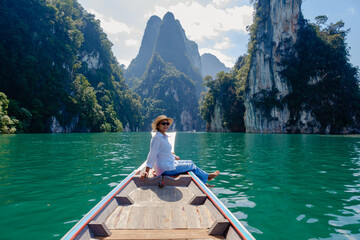 Experience tranquility on Cheow Lan Lake with stunning limestone cliffs in Khao Sok Thailand