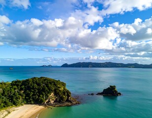 Aerial view of coastal landscape with ocean, islands, and clouds