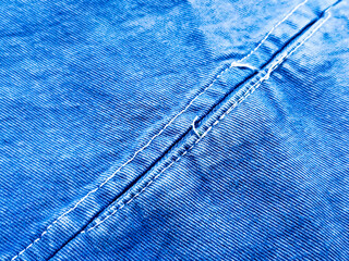 blue jeans background Closeup, macro of blue jeans denim fabric texture background. Diagonal weaving jean cloth, canvas. Textile for decor, upholstery, garment. Wallpaper, backdrop.